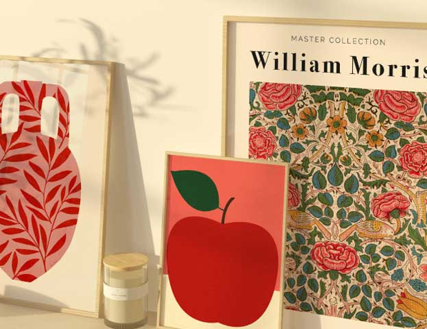 A harmonious composition of three framed posters: a William Morris exhibition poster, a stylised vase with leaves, and a minimalist apple