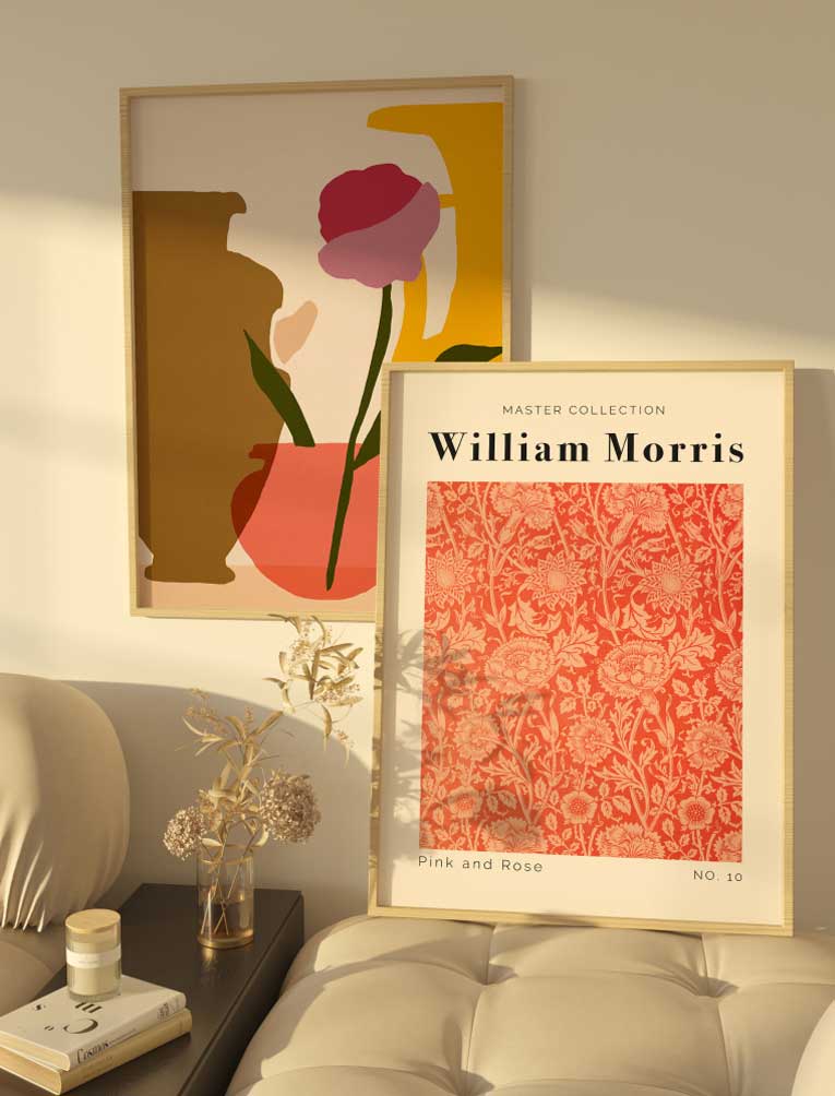 A stylish interior with two framed posters: a floral William Morris design and an abstract floral composition