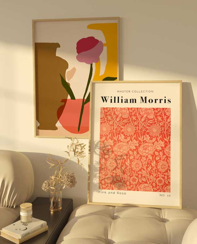 A stylish interior with two framed posters: a floral William Morris design and an abstract floral composition