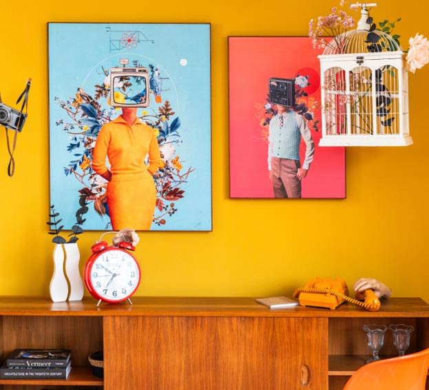 Colourful interior scene with Frank Moth artworks and retro decor against a yellow wall