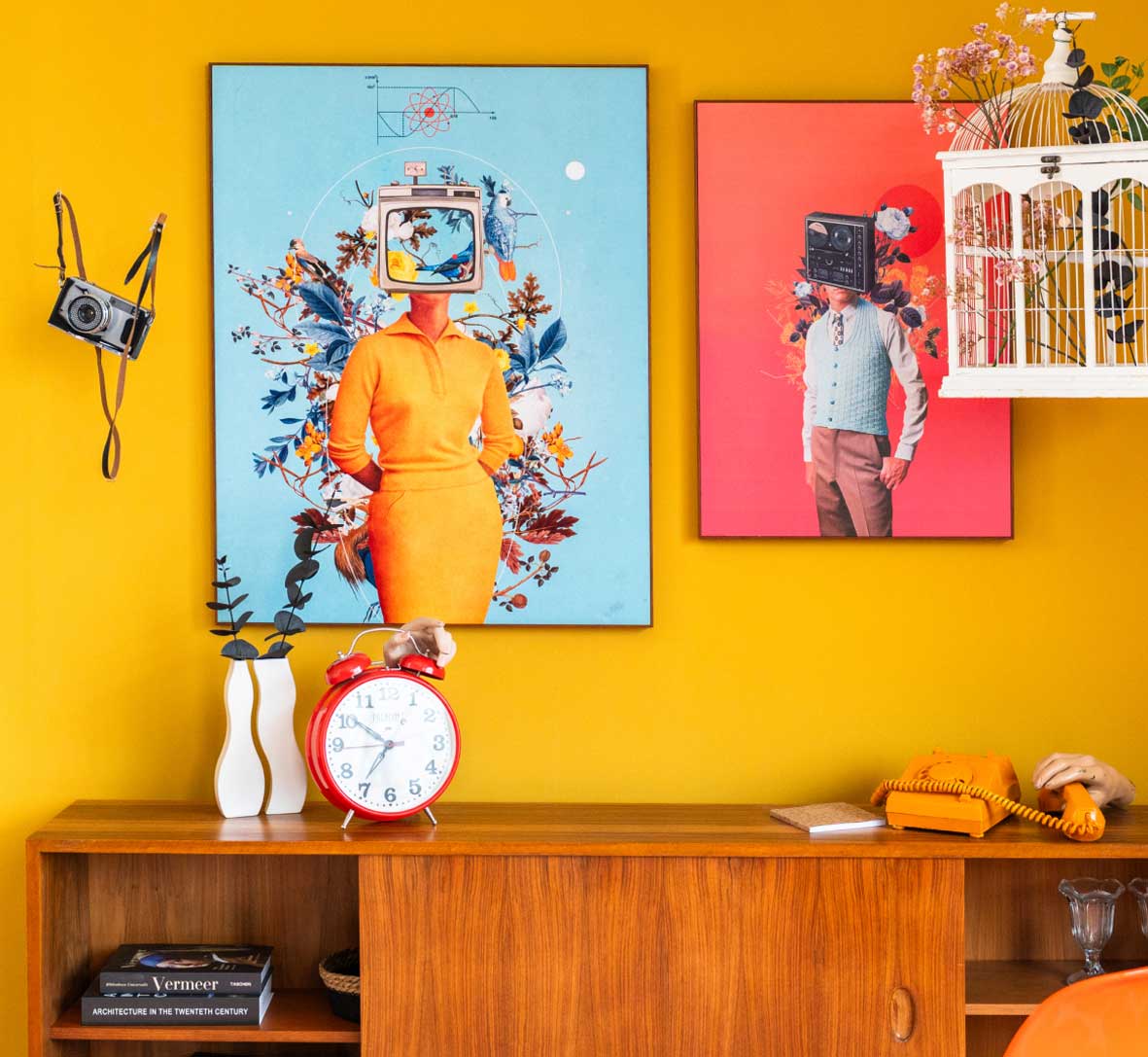 Colourful interior scene with Frank Moth artworks and retro decor against a yellow wall