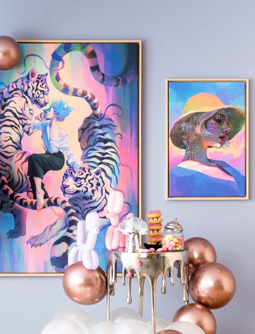 Colourful wall art with balloons, sweets, doughnuts and a disco ball on a golden dripping table