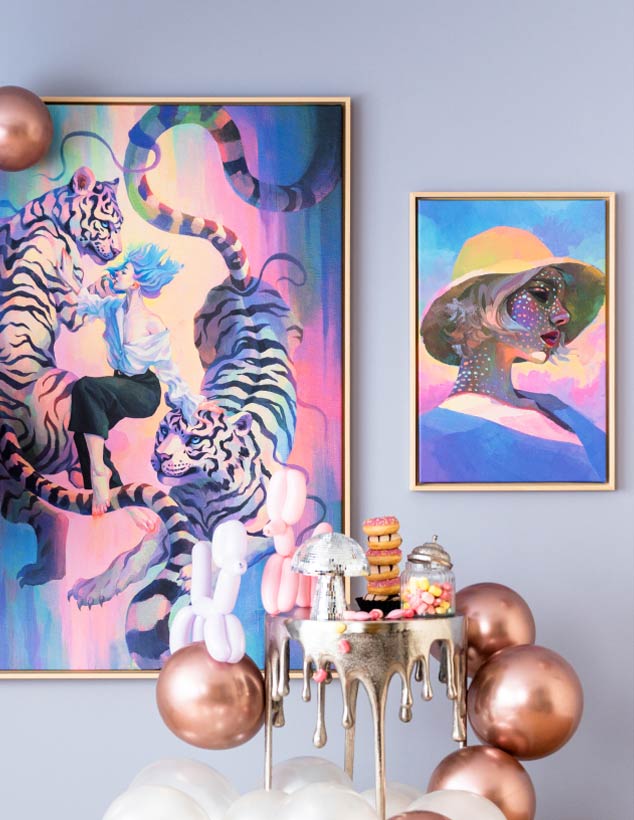 Colourful wall art with balloons, sweets, doughnuts and a disco ball on a golden dripping table
